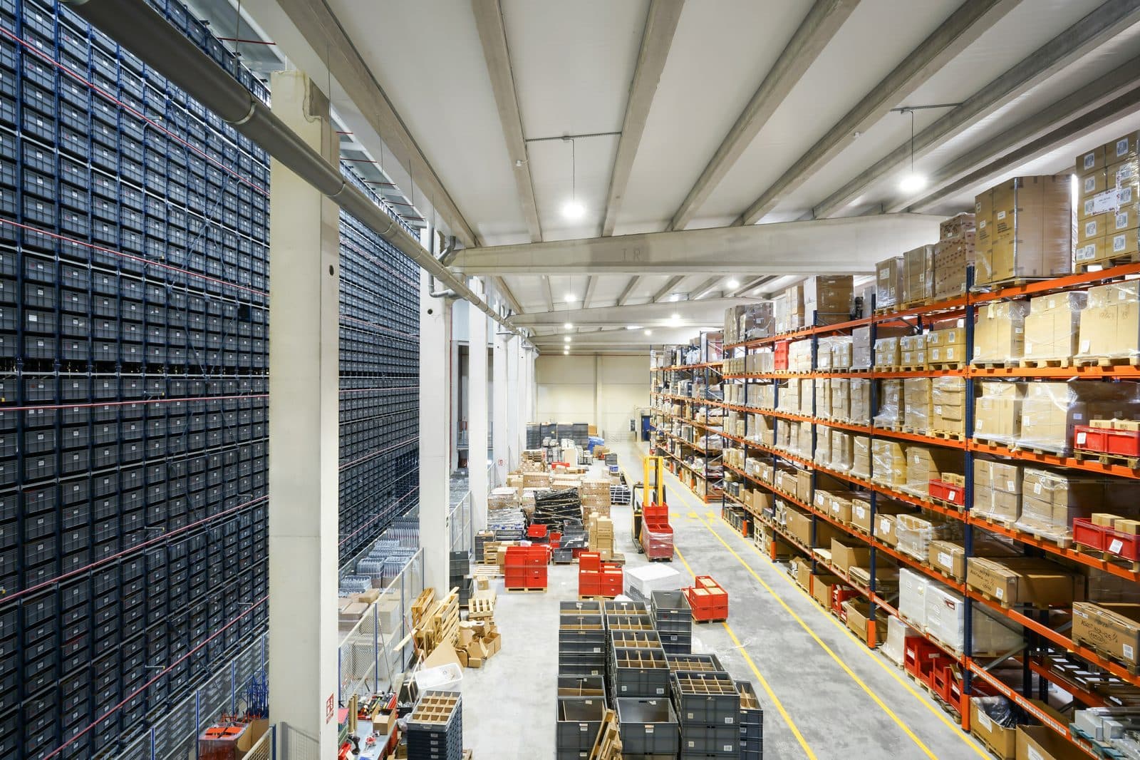 A fulfillment warehouse with racks of packaged product and pick stations.